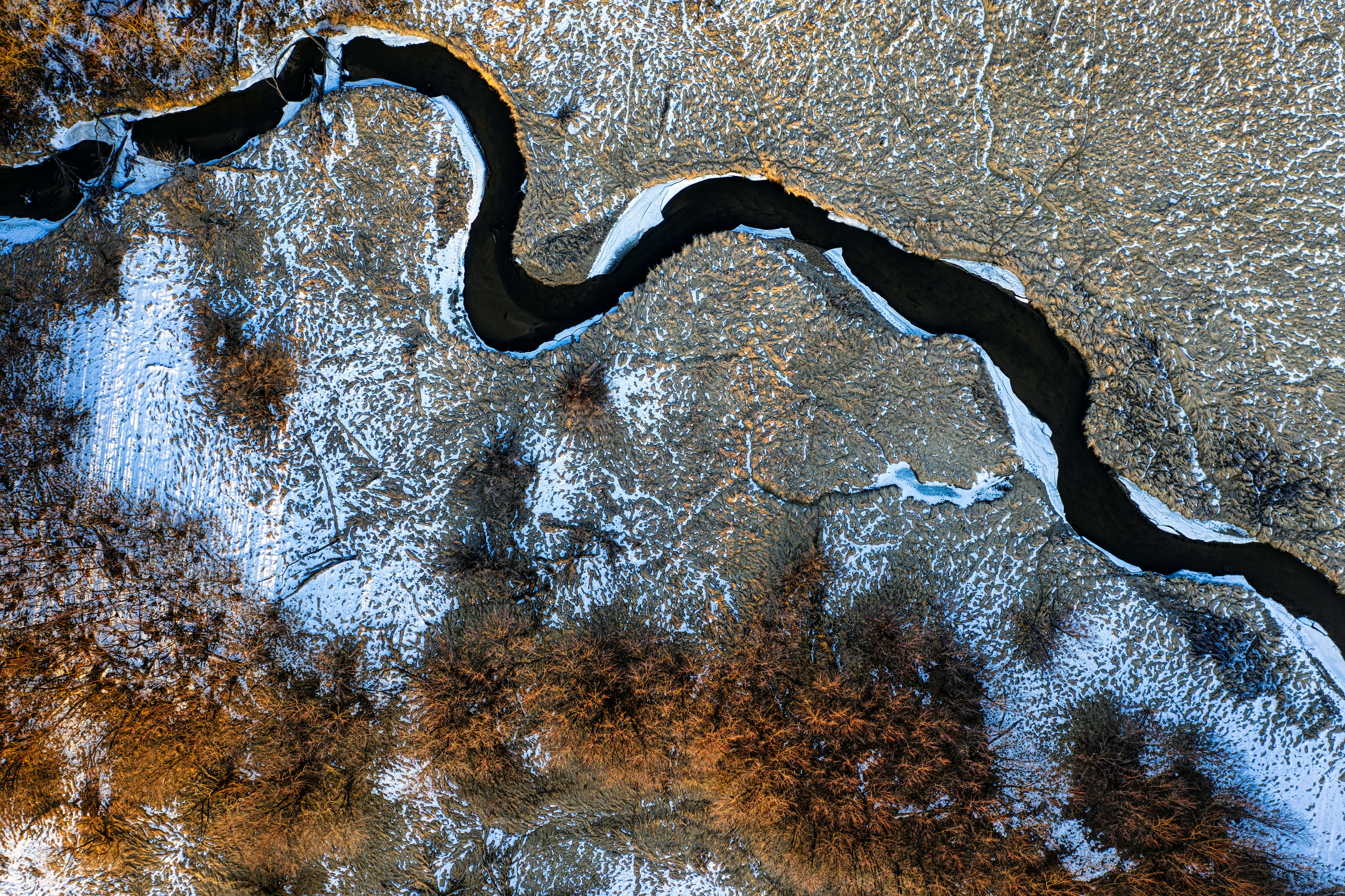 Aerial view of a river winding through a landscape — representing paths forward